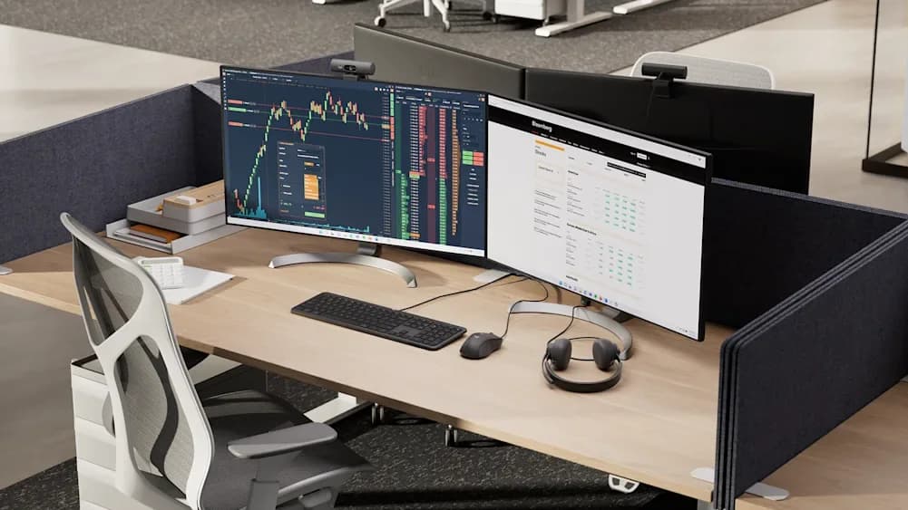 Business workstation with two monitors, keyboard, headset, and desk chair