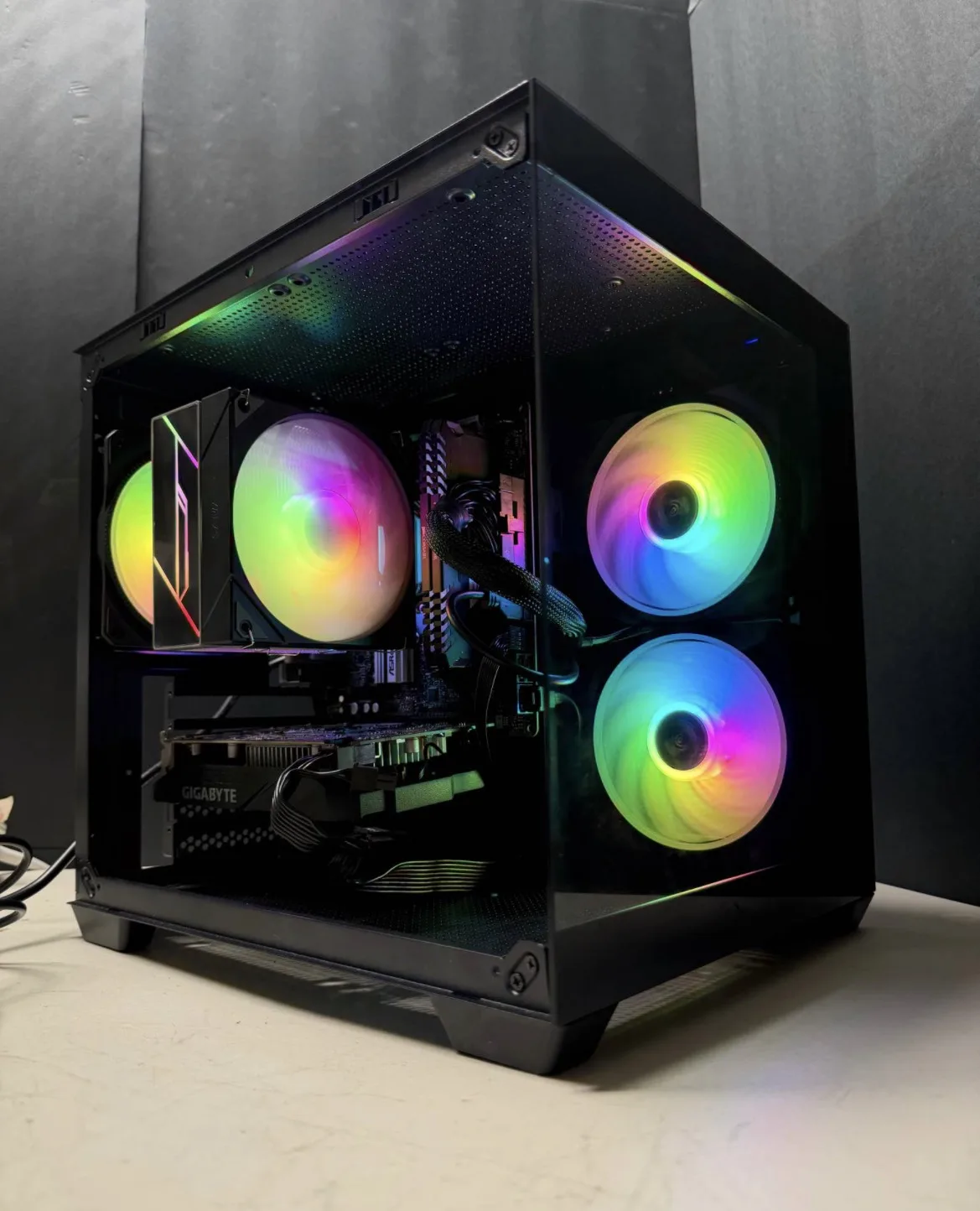 Compact black PC build with colorful front fans and an air cooler