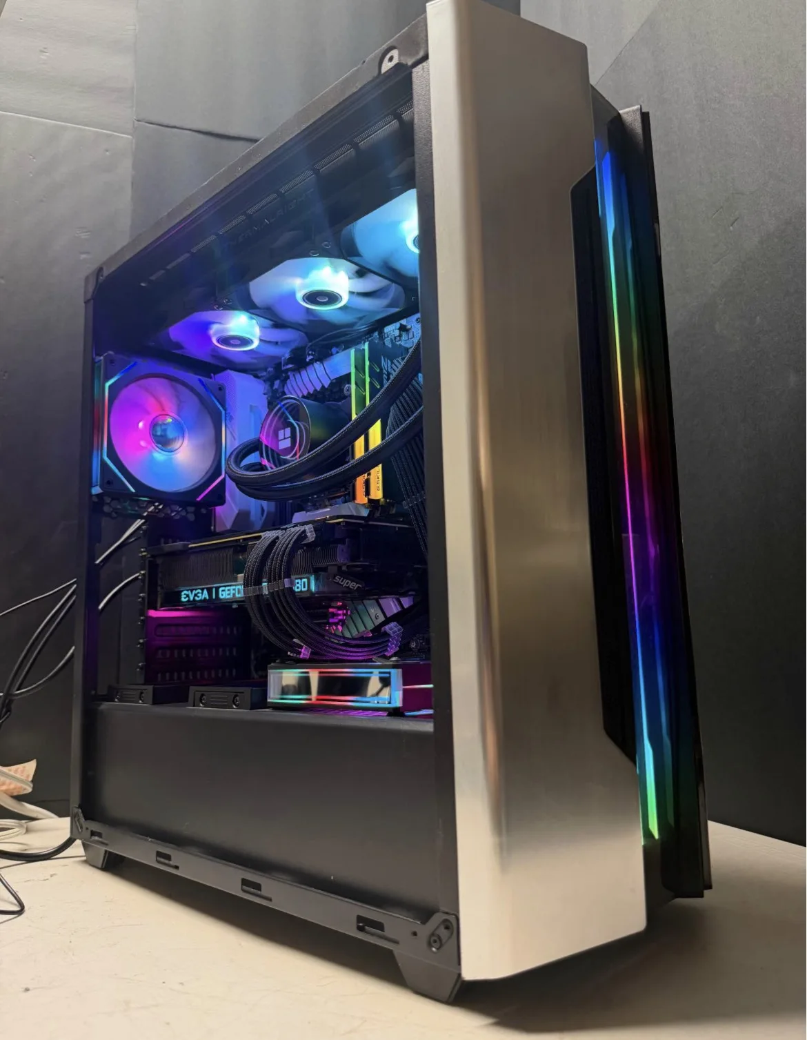 Full-size PC tower with liquid cooling, a graphics card, and RGB lighting