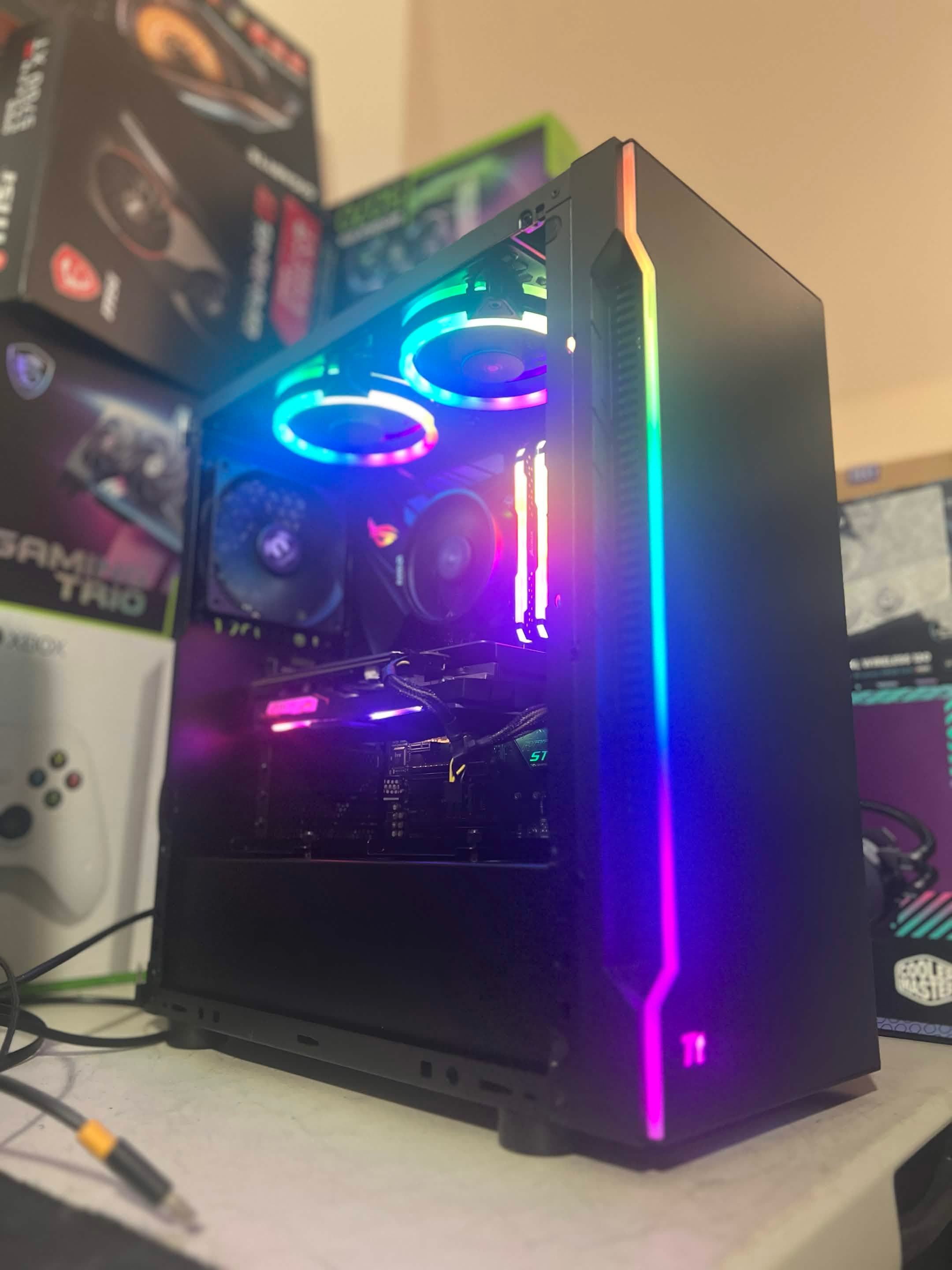 Black gaming PC with multicolor front light strips and RGB fans