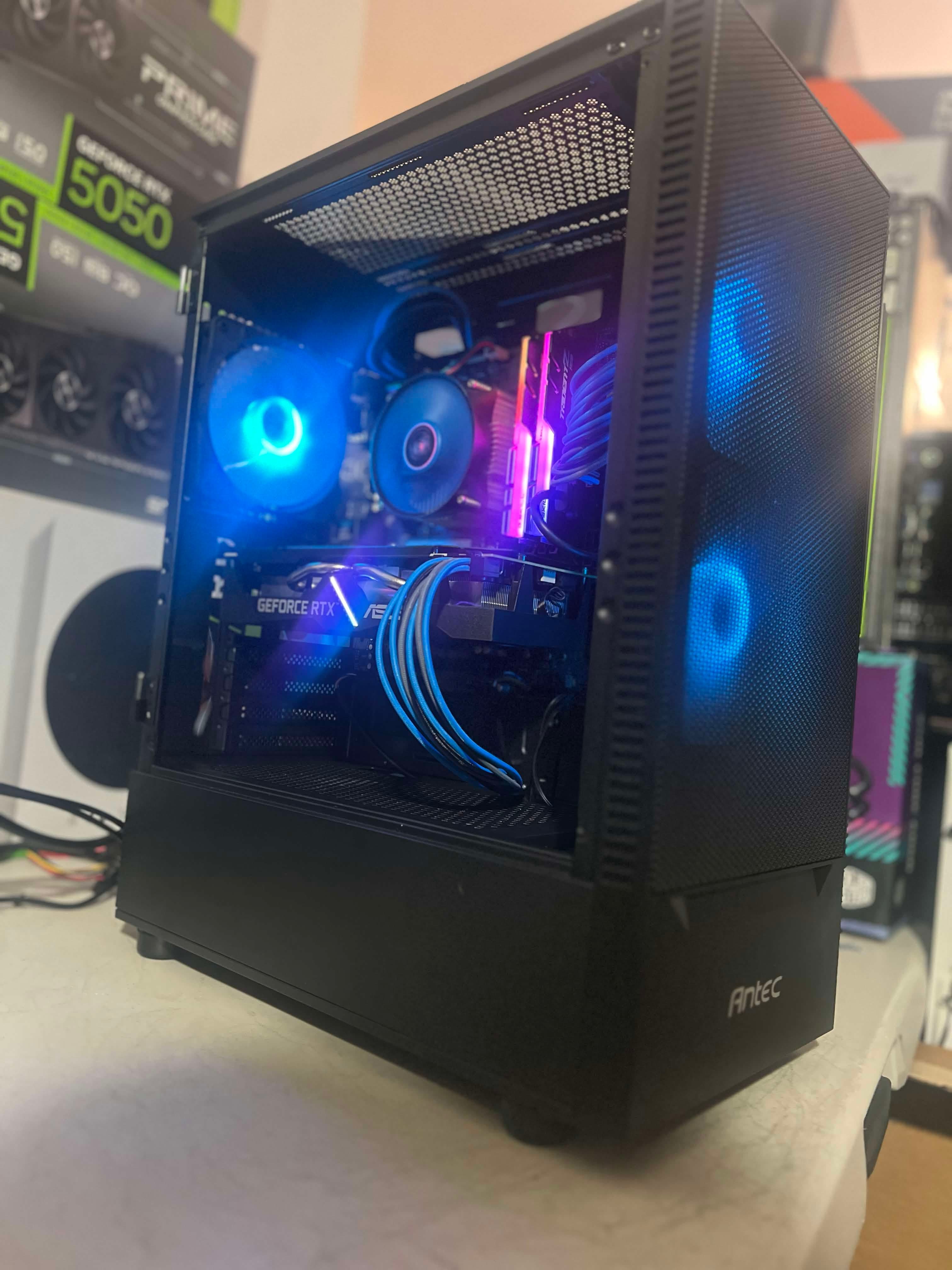 Black gaming tower with blue fans and pink-lit memory