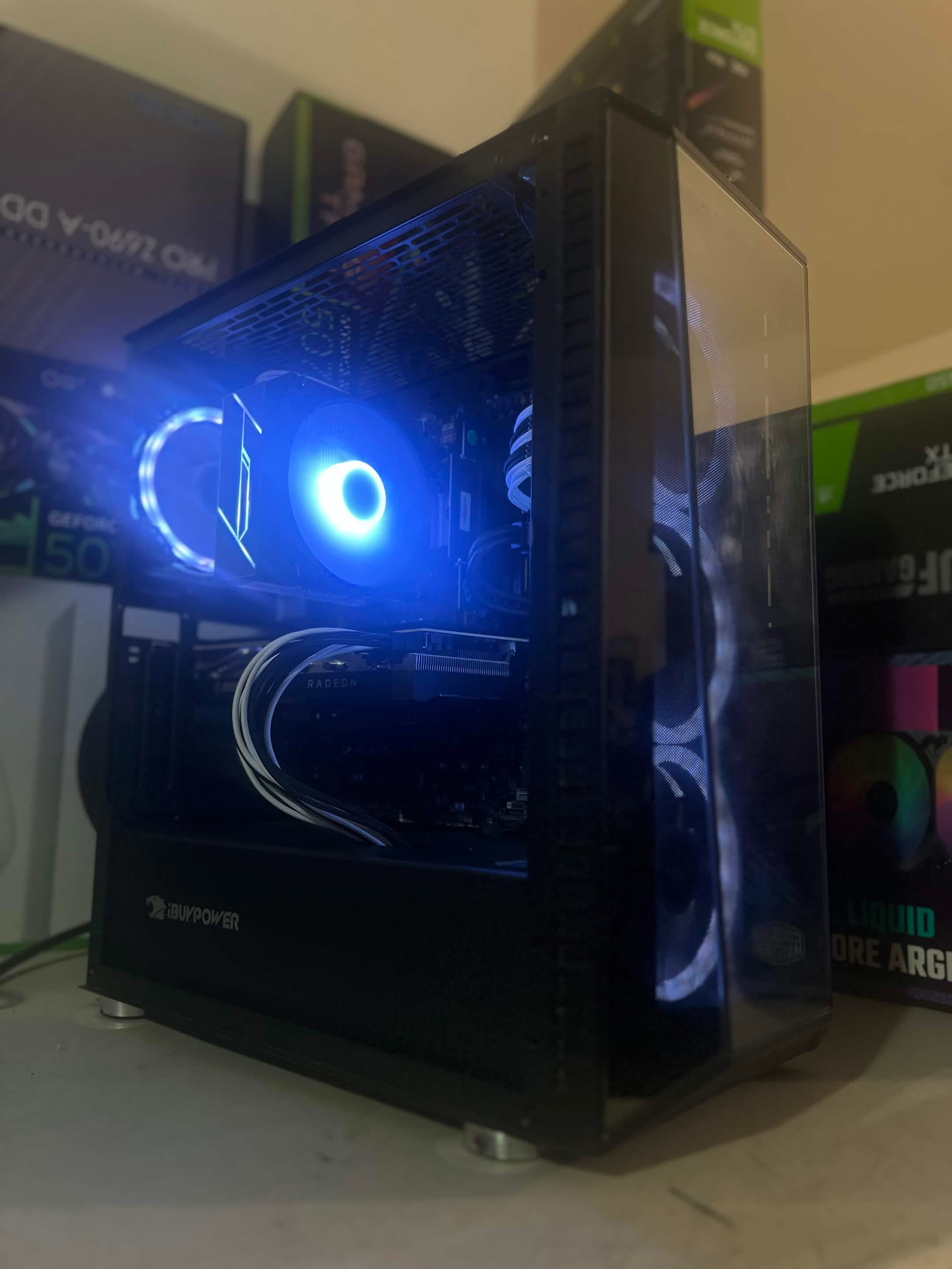 Black glass-panel gaming PC with blue fans and white cabling